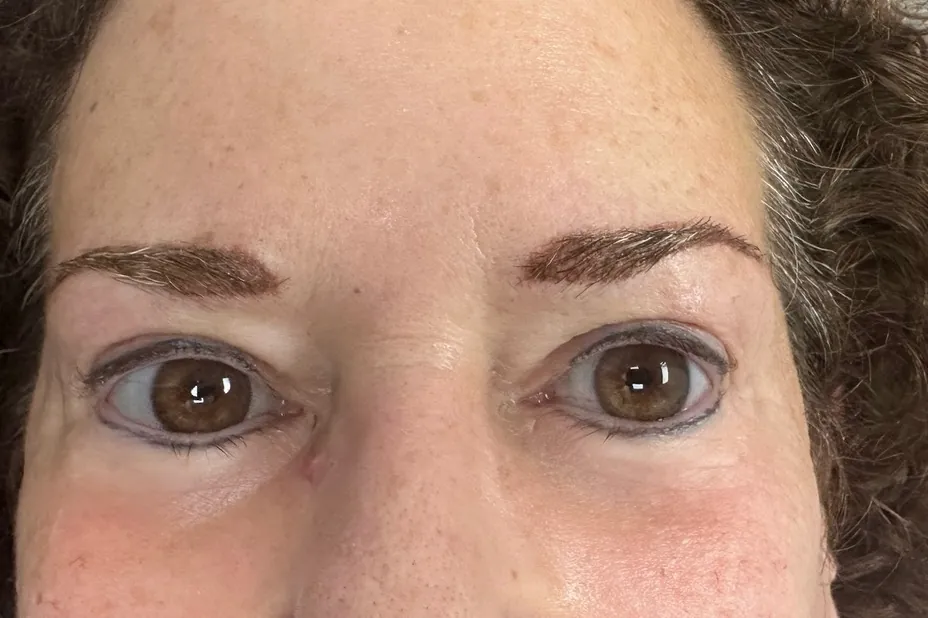 After: the same client immediately after the procedure, with fuller, warm brown brows