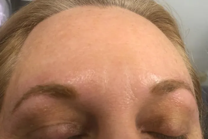After: the same brows immediately after the procedure, filled in with soft, warm color