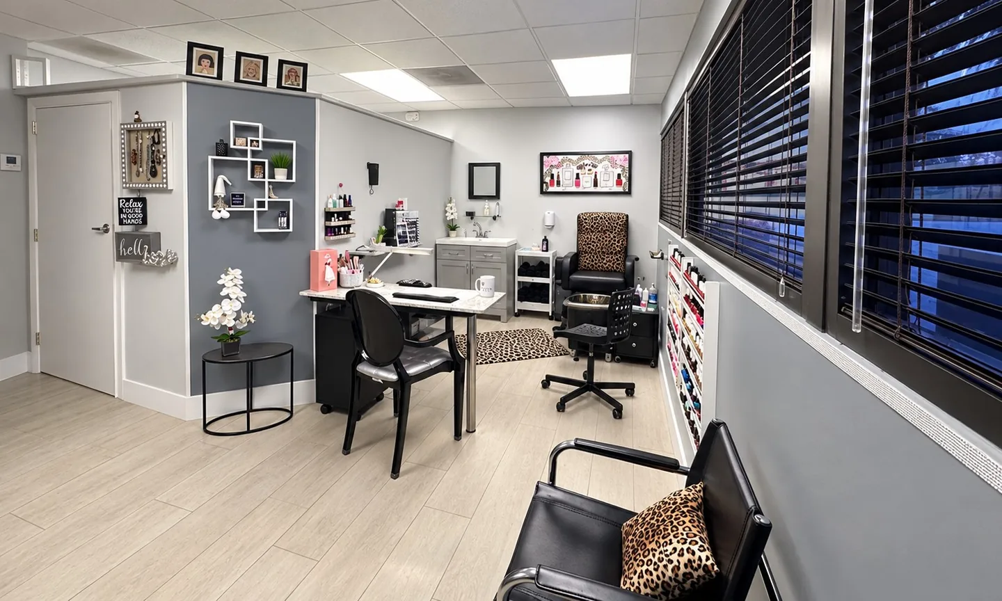 The bright main room of the studio, with a work table, a reclining chair and a wall of shelves